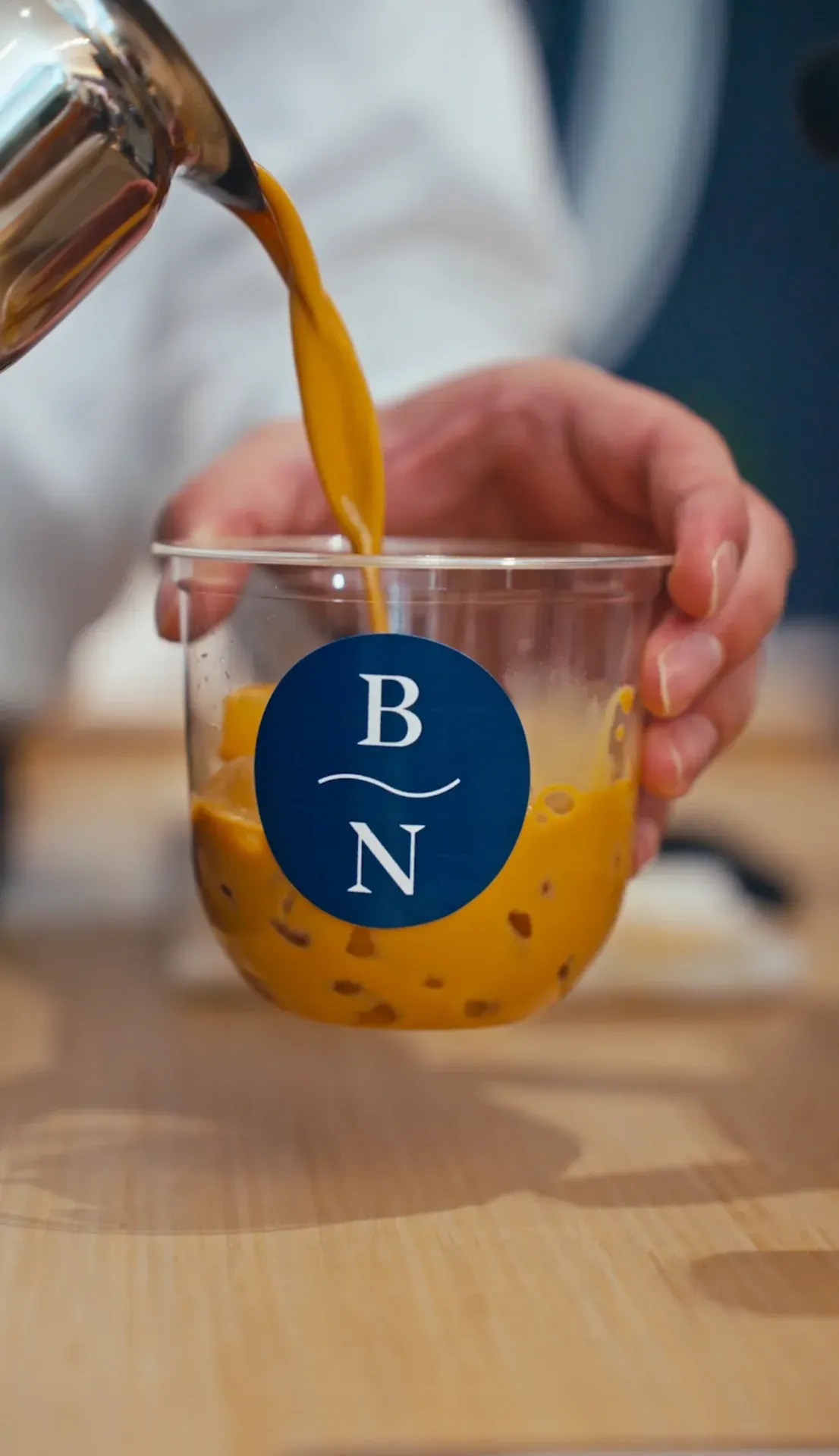 Espresso being poured into a custom Blue Nile branded cup at the Fez Coffee bar.